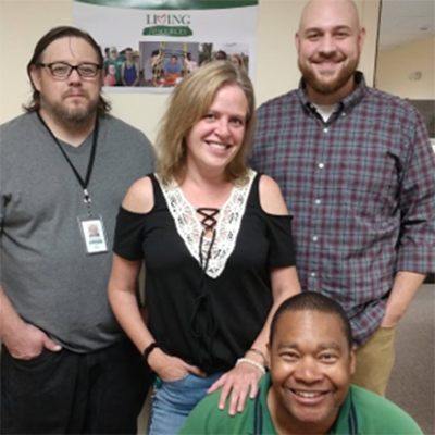 Staff members smiling in a communal area