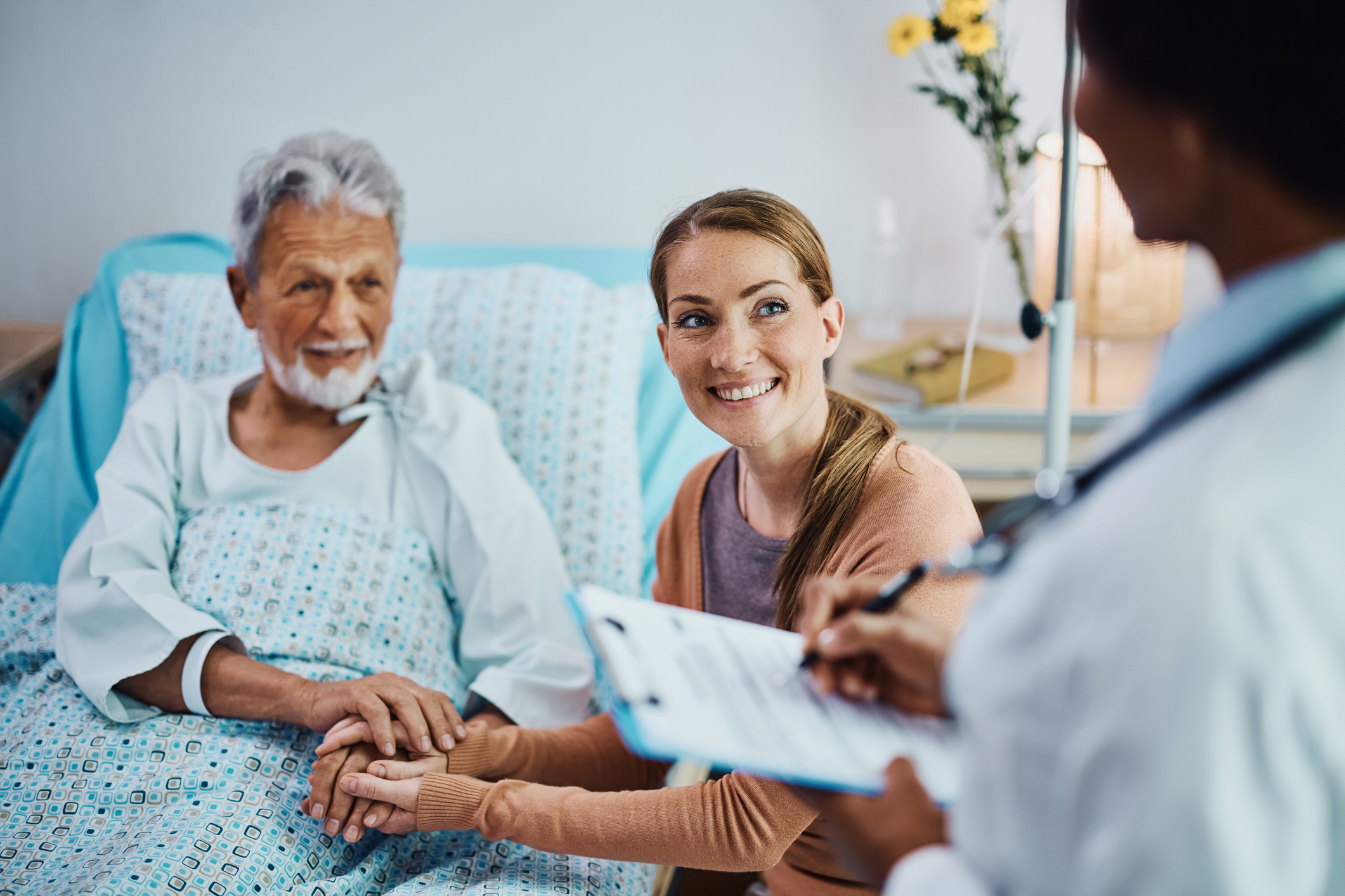 Nurse interacting with a patient and family member