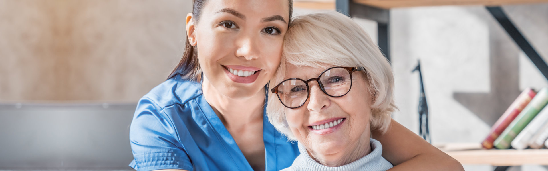 Caregiver and resident smiling together