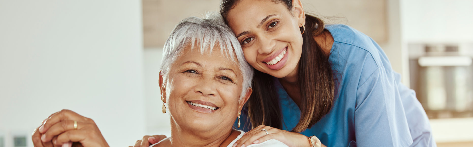 Caregiver smiling with senior resident