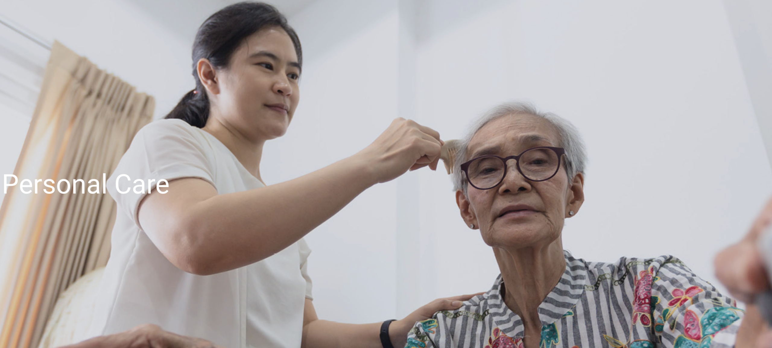 Care staff assisting an elderly resident