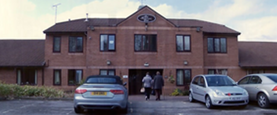 Exterior view of St Bartholomew's Court with residents entering