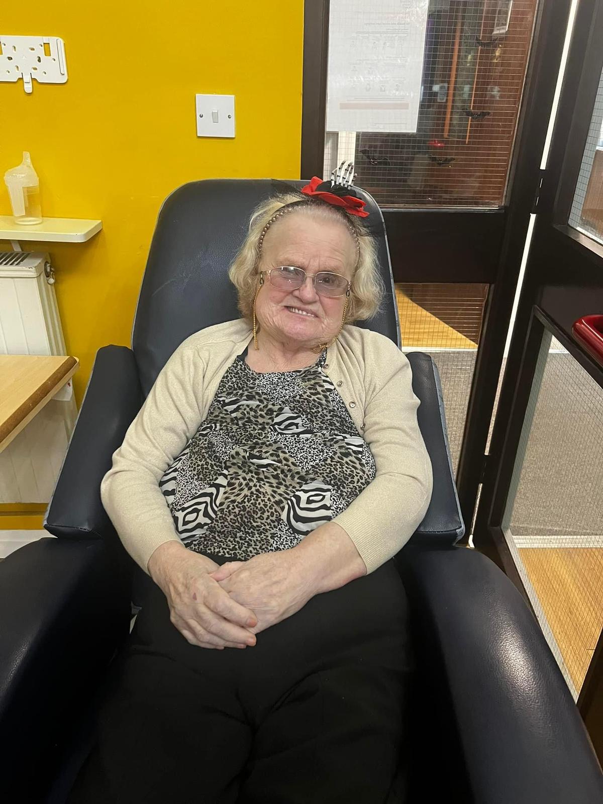 Senior resident relaxing in a chair indoors.