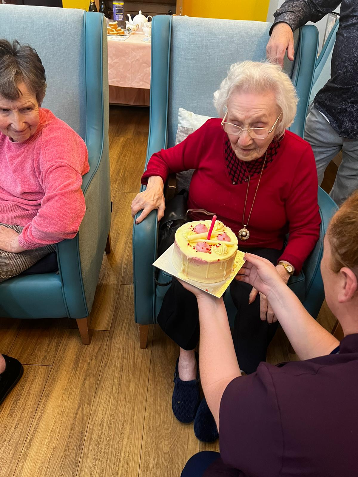 Residents celebrating with a birthday cake