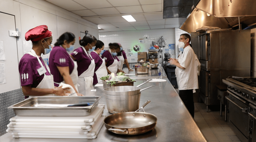 Kitchen staff preparing food in a facility kitchen