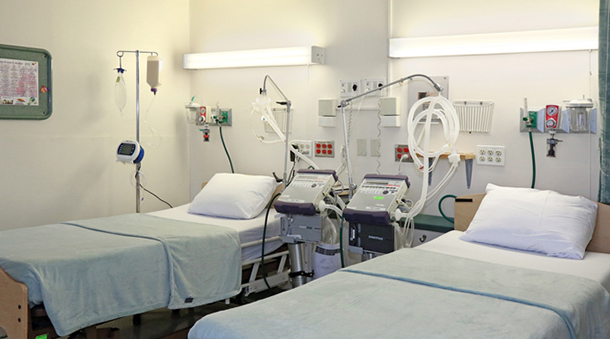 Patient rooms with hospital beds and medical equipment