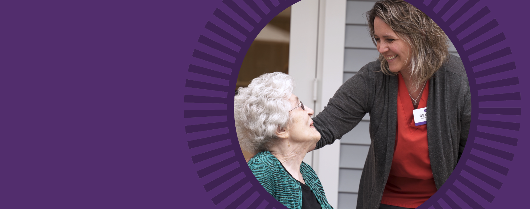 Staff member interacting with a resident smiling