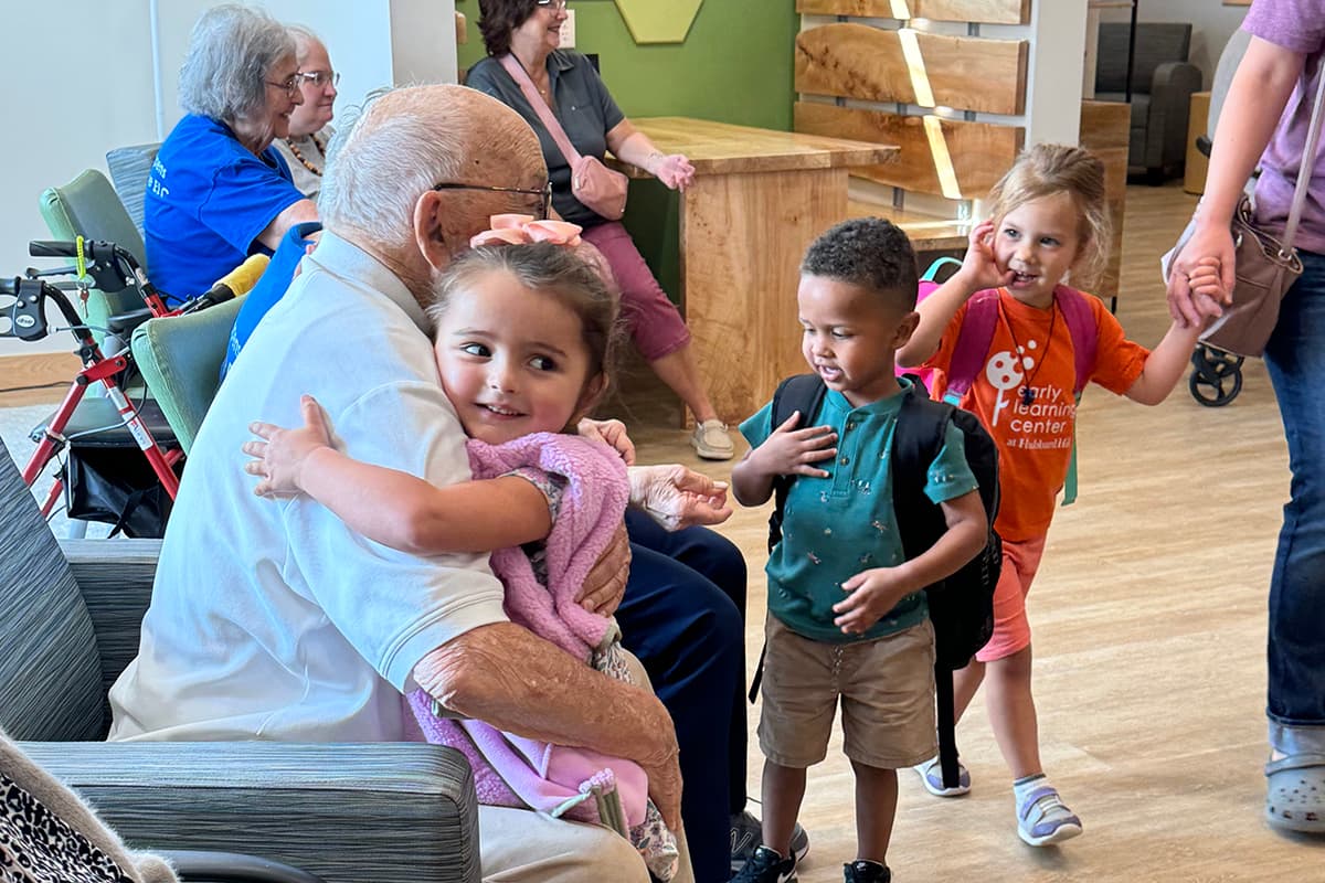 Residents interacting with children in a common area