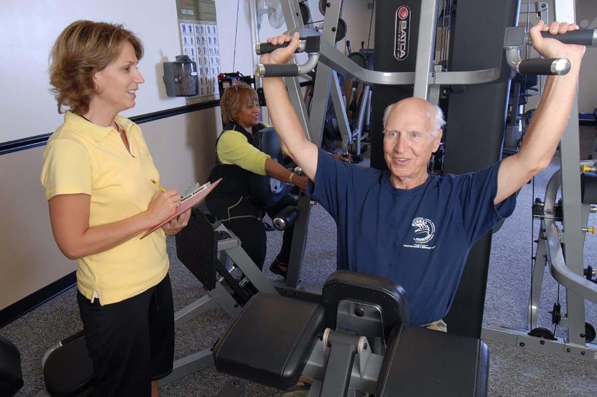 A fitness activity with a staff member assisting a resident