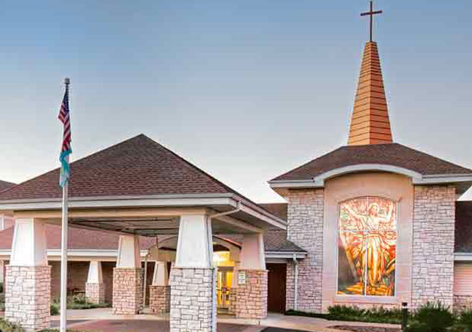 Exterior view of the facility entrance with a religious symbol