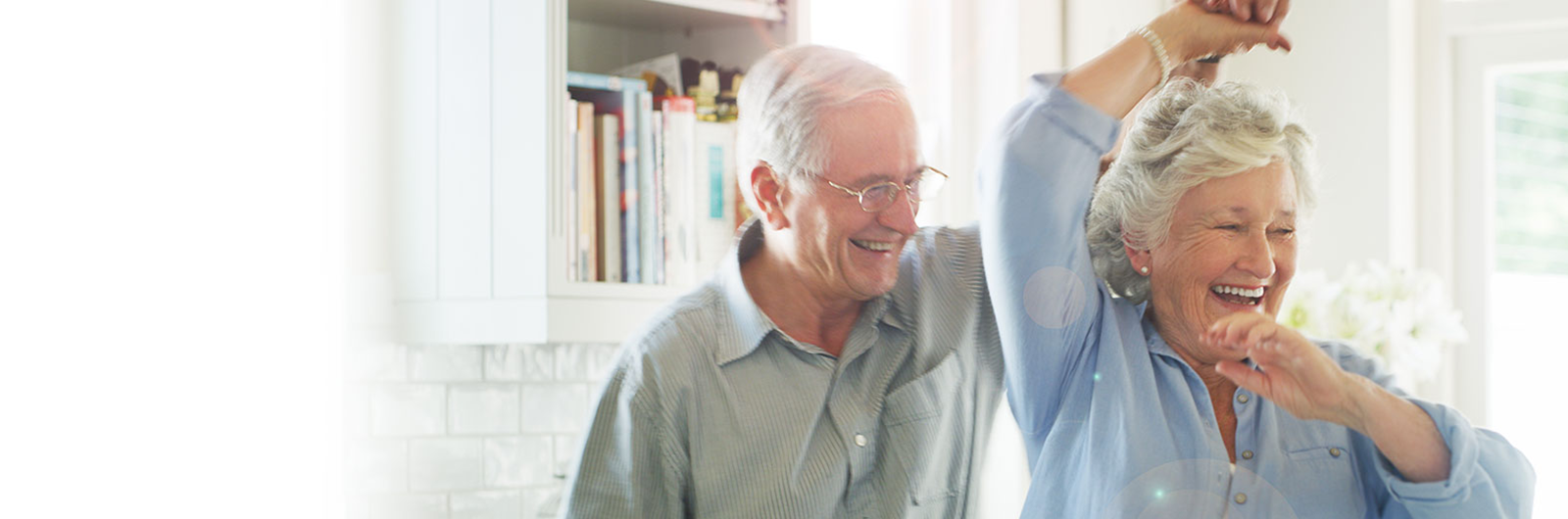 Couple dancing joyfully in a bright living space