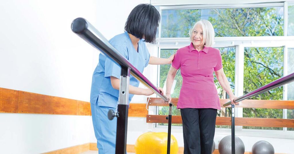 Staff assisting a resident with therapy exercises