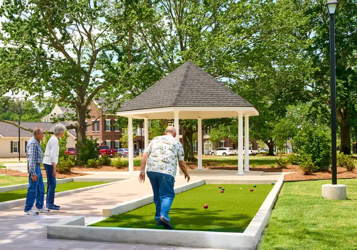 Residents participating in outdoor bocce ball game