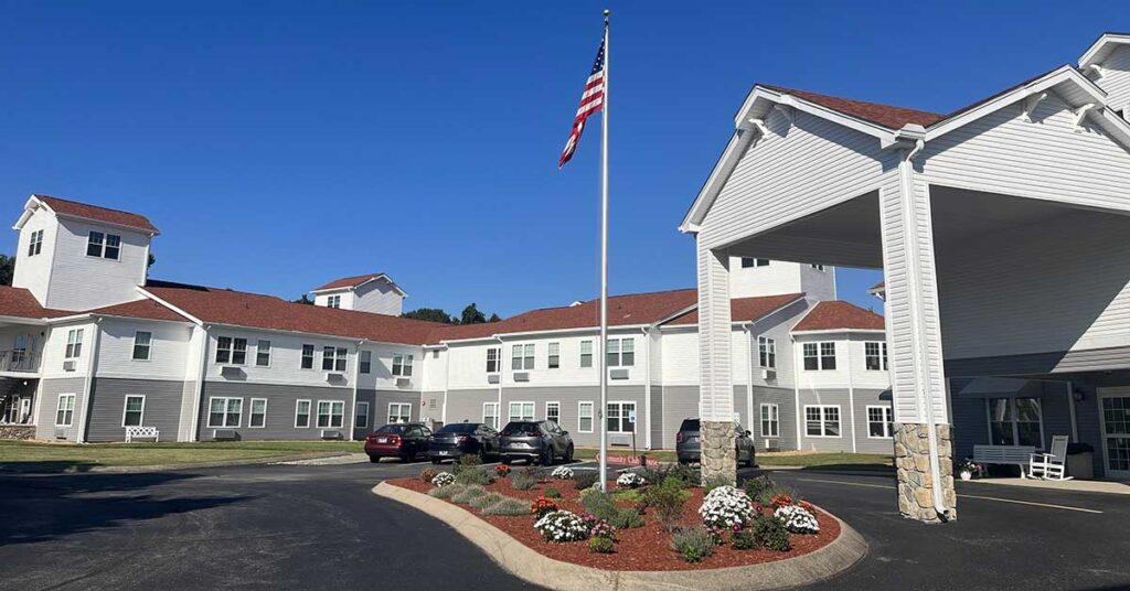 Front entrance of Antioch Valley Senior Living with flag