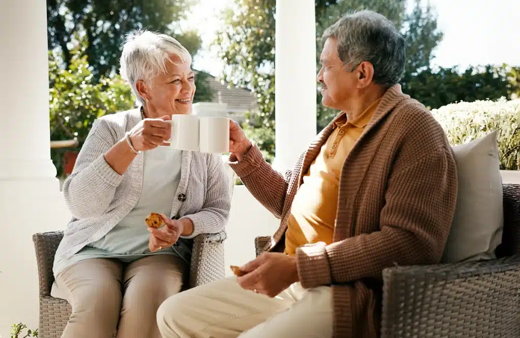 Couple enjoying tea on a sunny porch