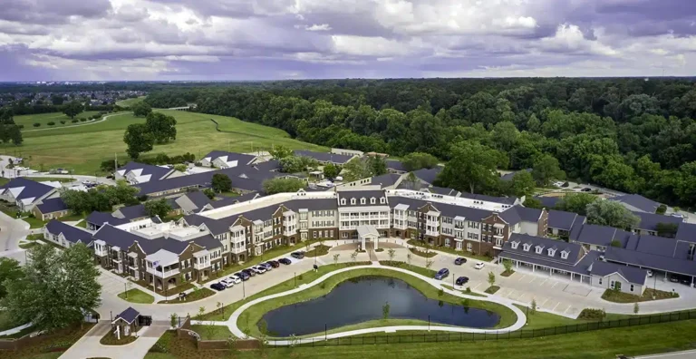 Aerial view of a senior living facility with landscaped grounds