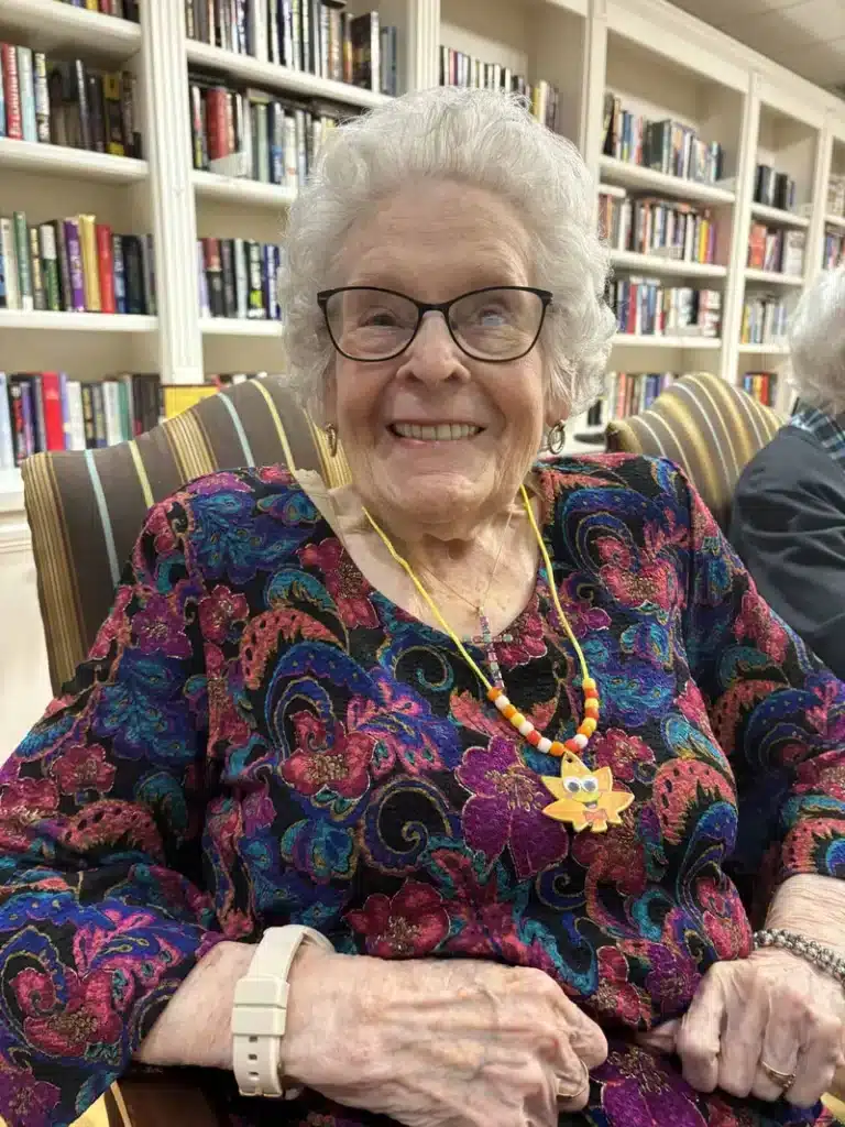 Senior resident smiling in a common area