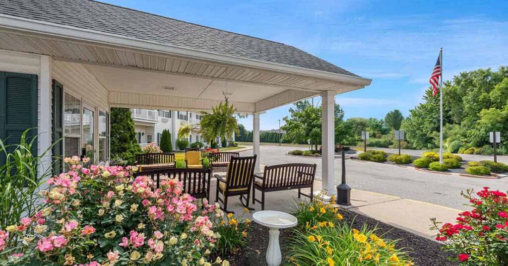 Outdoor seating area with flowers and building entrance