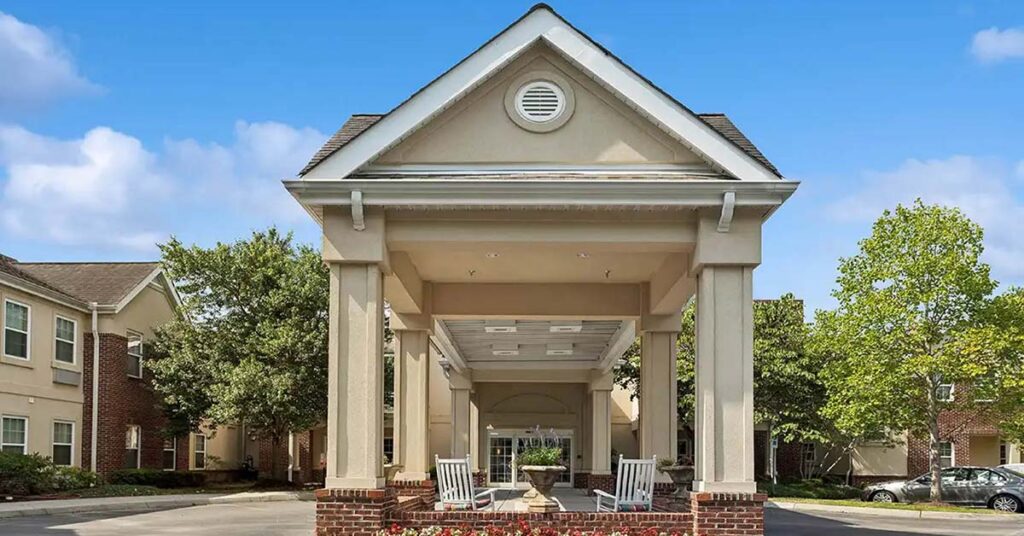 Front entrance of a senior living facility with rocking chairs