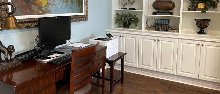 Interior view of a common area with a computer and furniture