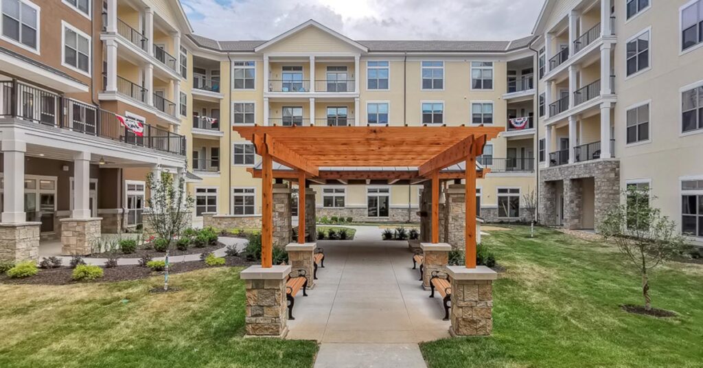 Outdoor courtyard with a wooden gazebo and benches