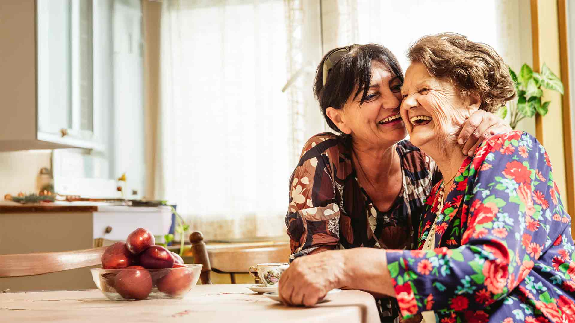A caregiver enjoying time with a resident in a bright room