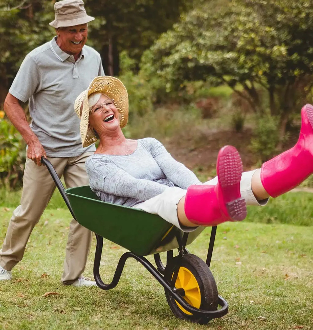 Residents enjoying outdoor fun with a wheelbarrow