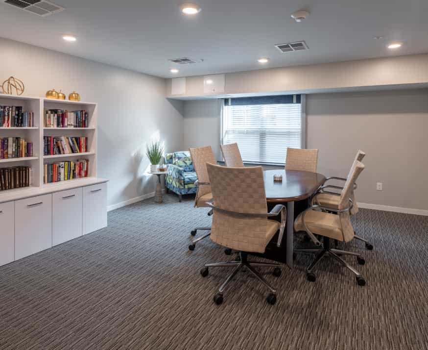 Bright meeting room with a round table and chairs.