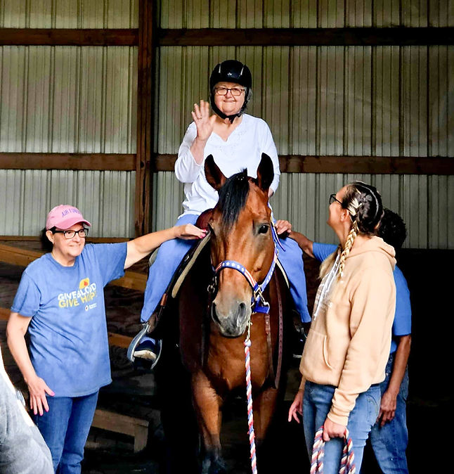Residents participating in equine therapy session.