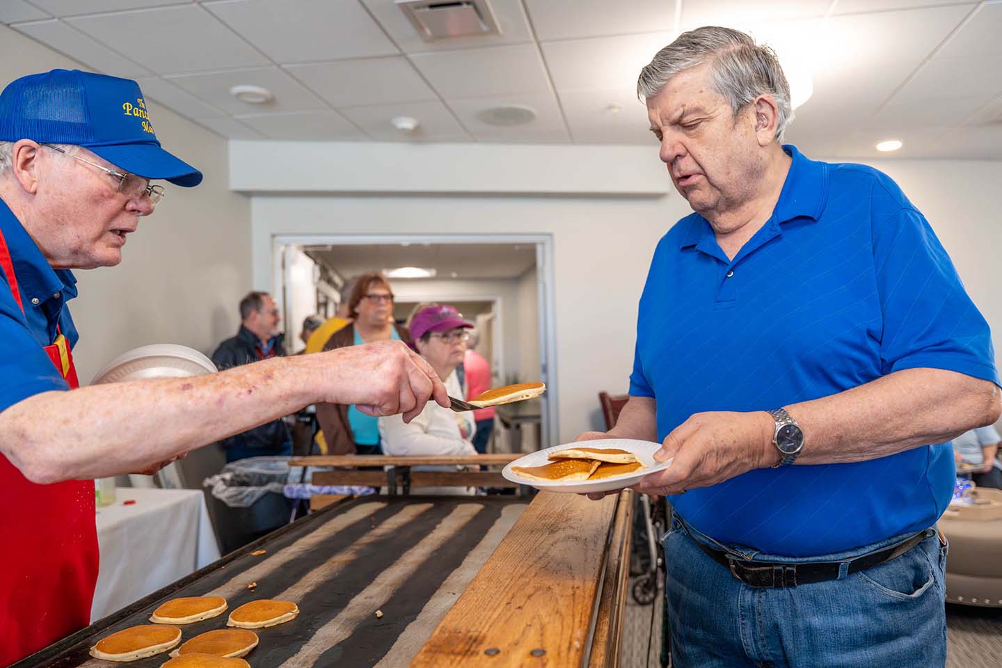 Residents enjoying pancakes during a community event.