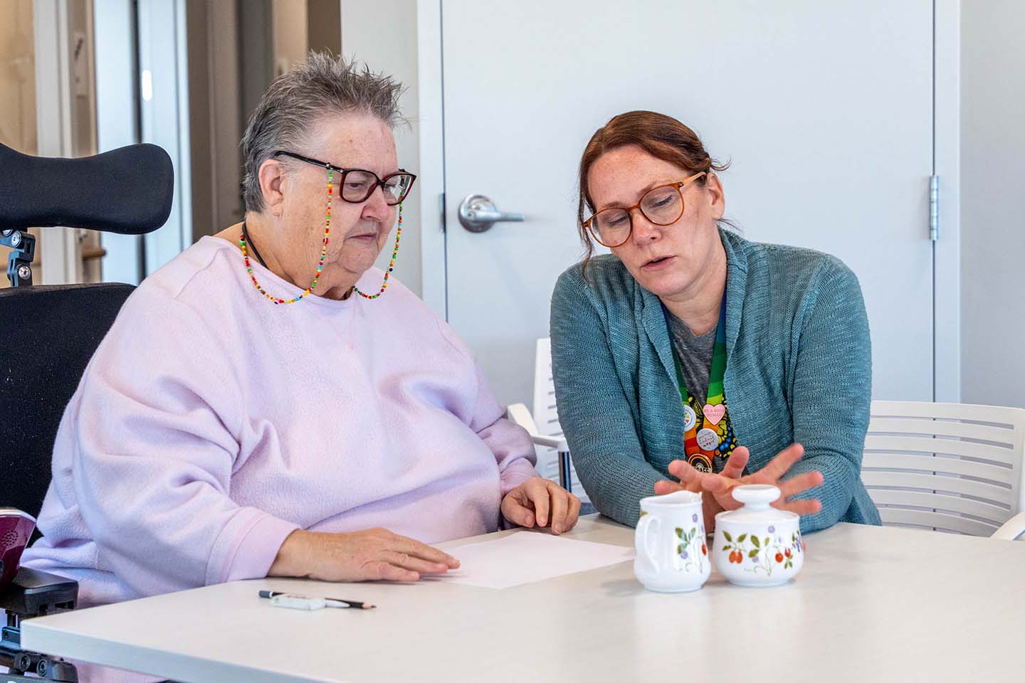 Resident and staff engaging in a conversation.
