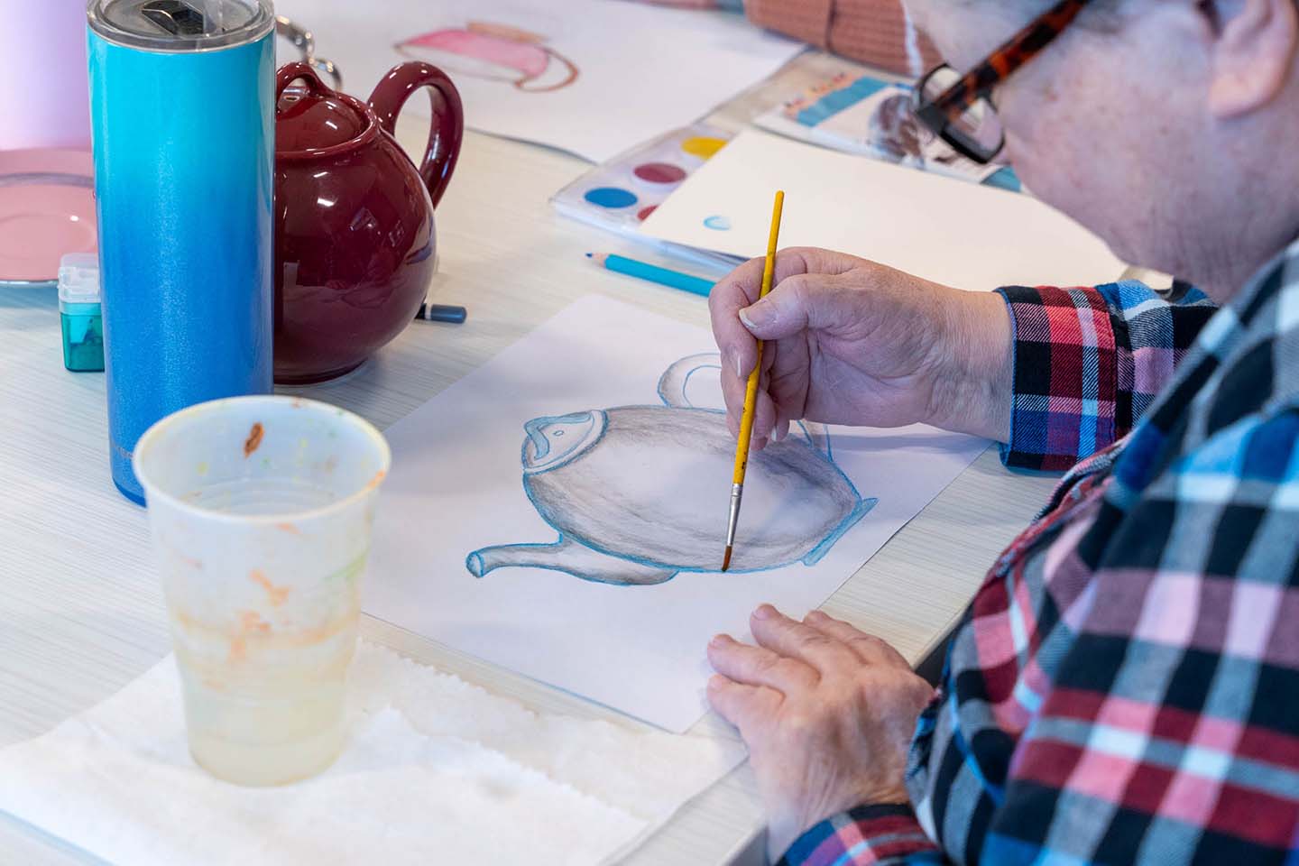 Resident painting during an art activity session.