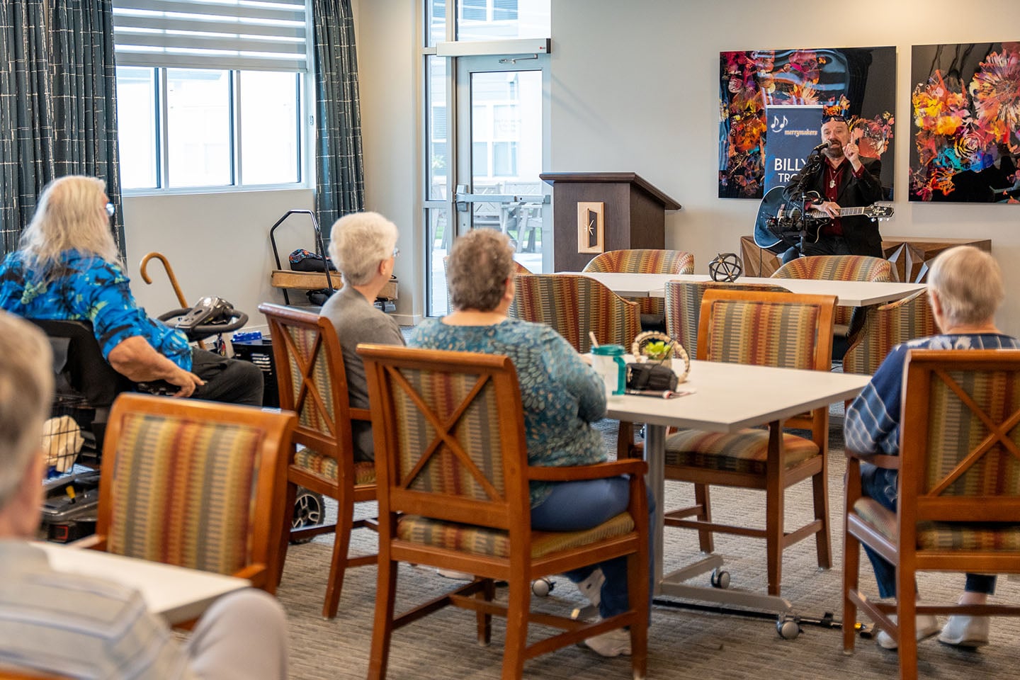 Residents attending a live performance in a common area.