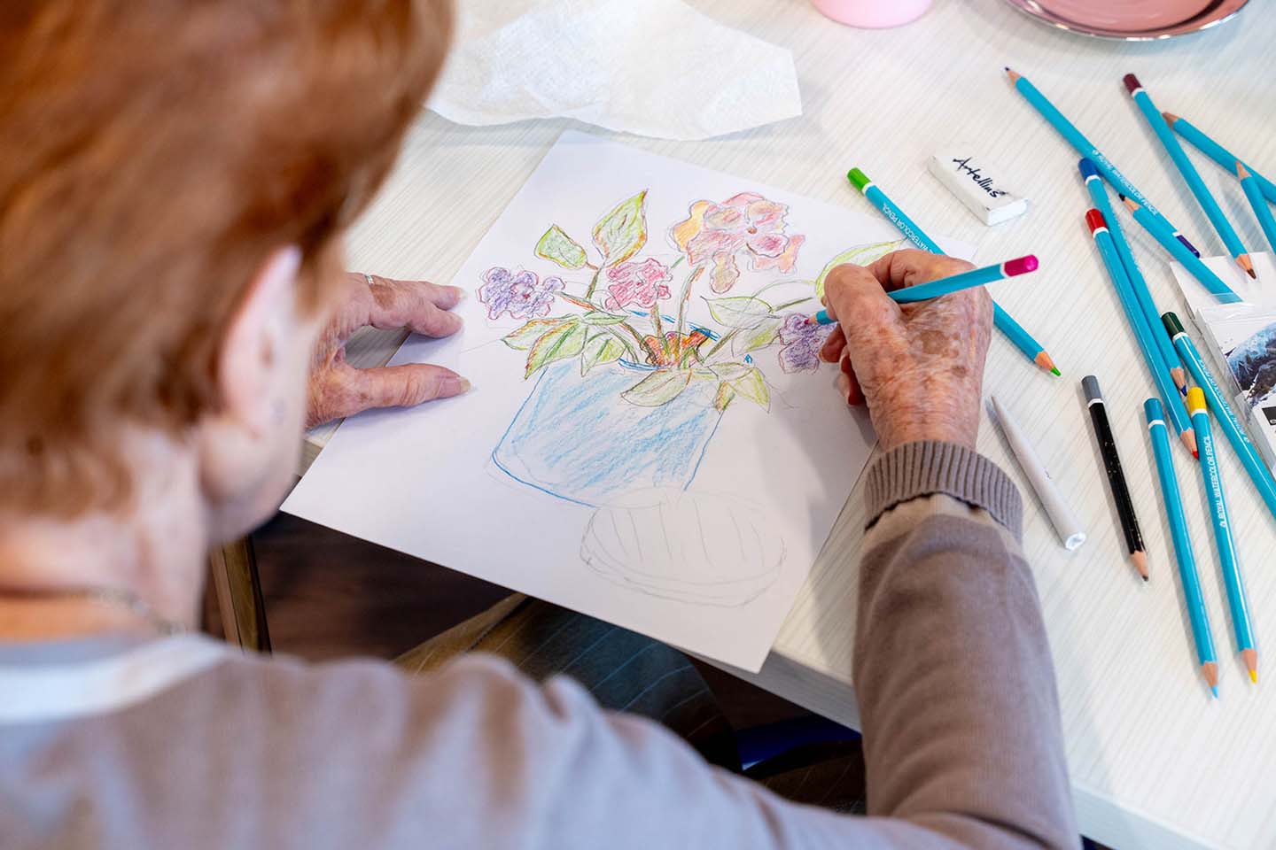 Resident coloring flowers with art supplies