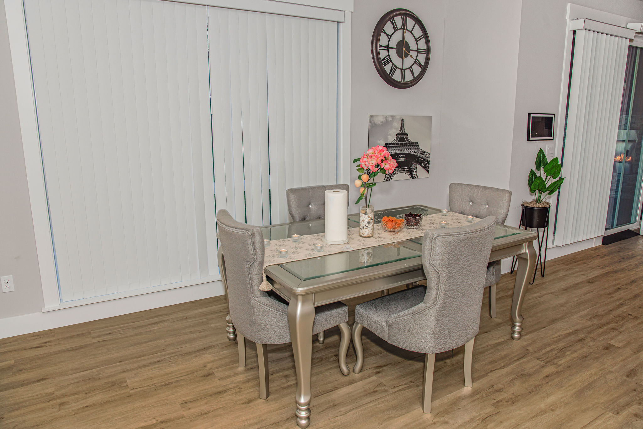 Elegantly set dining table with a floral centerpiece.