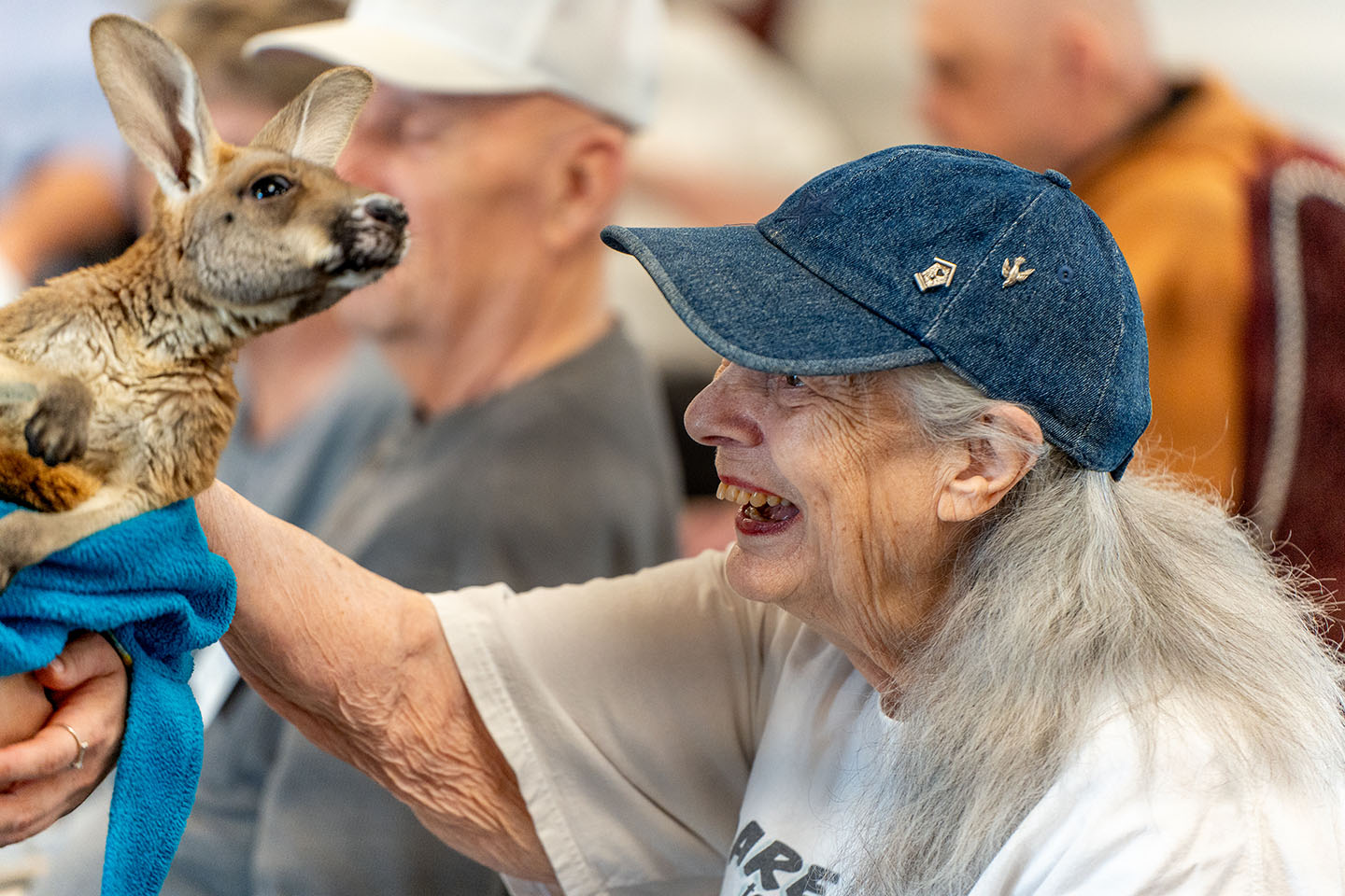 Senior resident interacting joyfully with a pet animal.