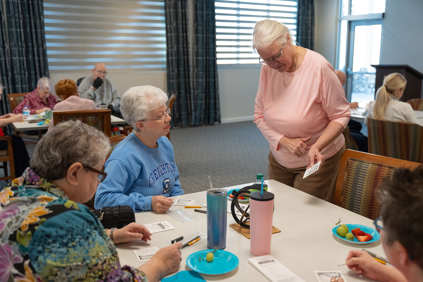 Residents engaging in an activity at a communal table.
