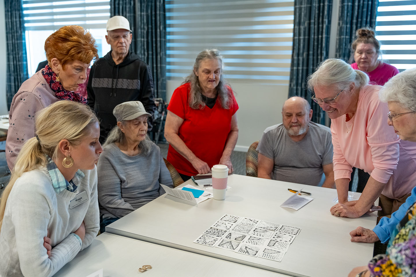 Residents engaged in a group activity around a table.