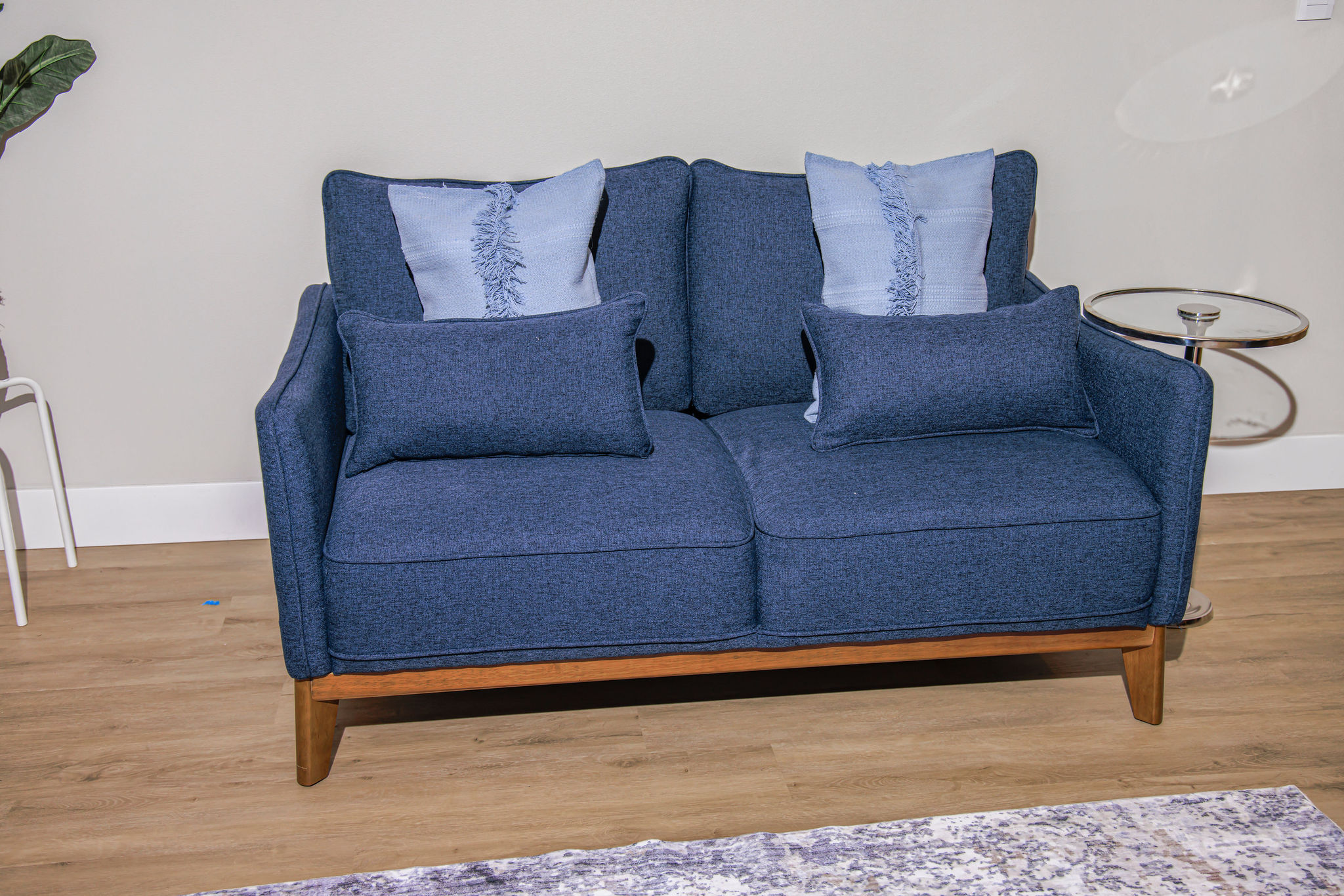 Cozy blue sofa with decorative cushions