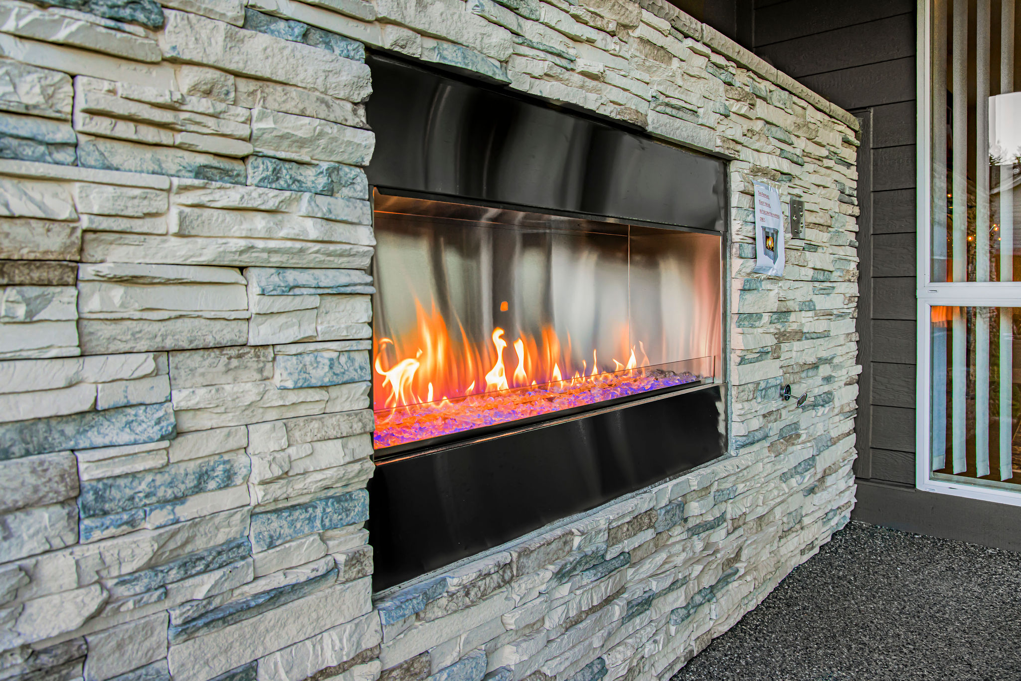 Modern outdoor fireplace with decorative stonework.