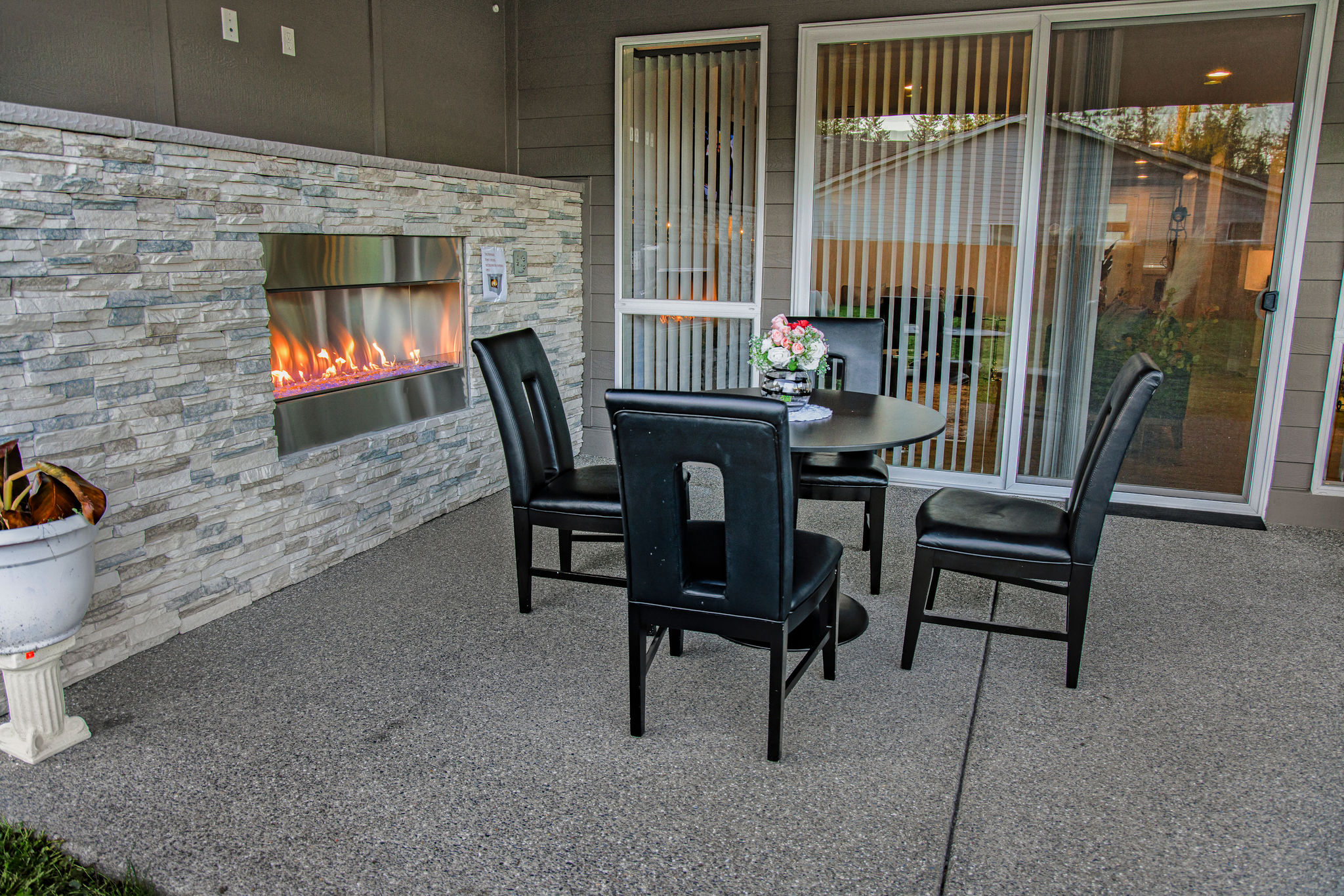 Patio area with a table and fireplace