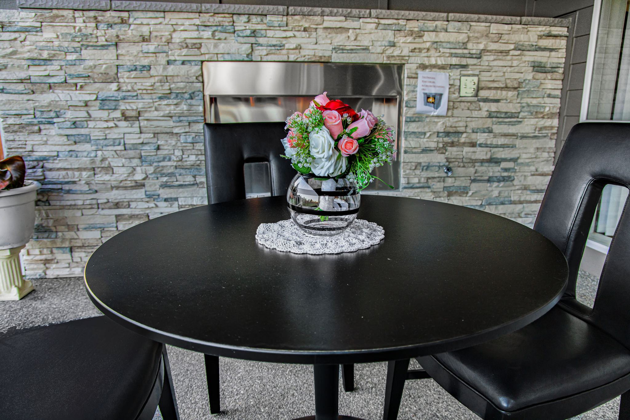 Outdoor table with a floral arrangement.