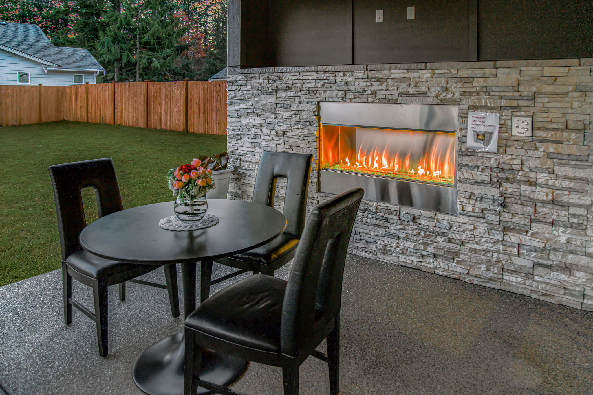 Outdoor space with a fireplace and seating area.