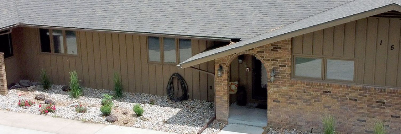 Exterior view of a facility building with landscaping.