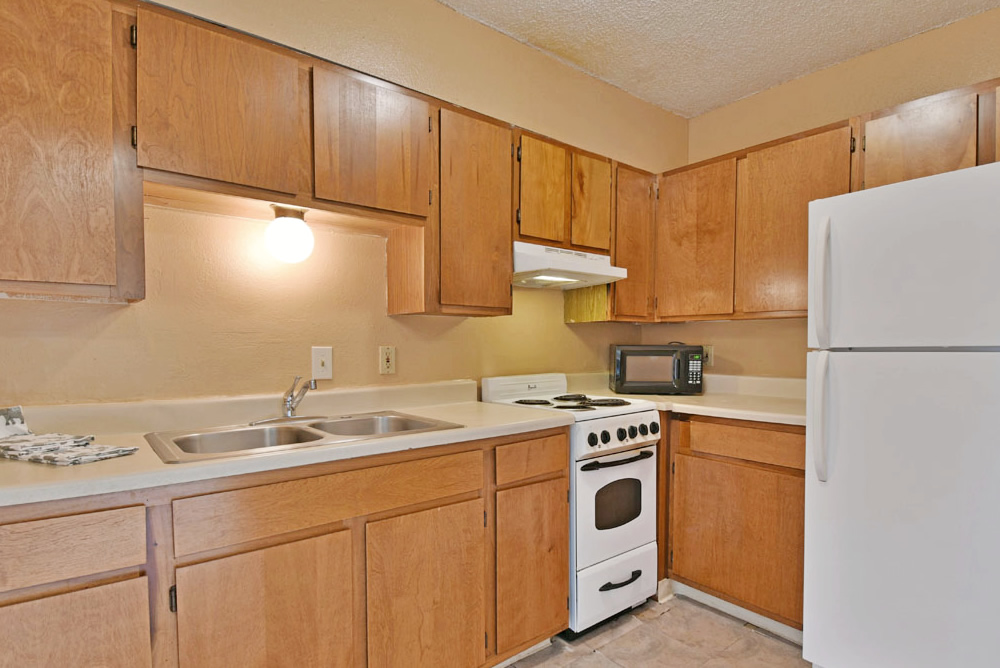 Cozy kitchen with wooden cabinets and appliances.