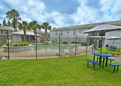 Outdoor pool area with seating and landscaping.