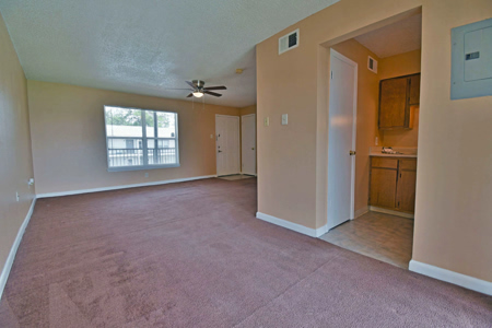 Spacious interior of a resident room with carpet.