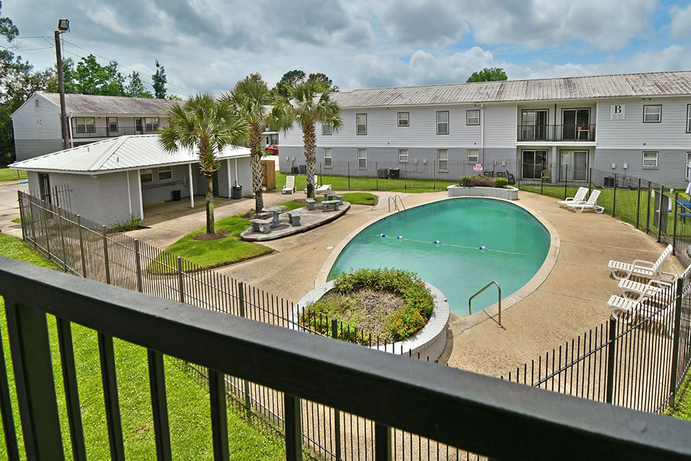 Outdoor pool area with surrounding buildings.