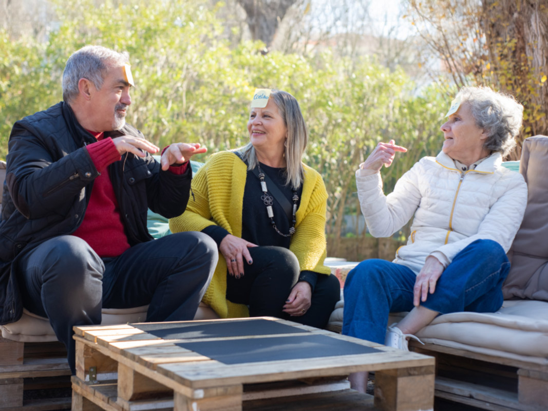 Residents enjoying conversation in an outdoor space.