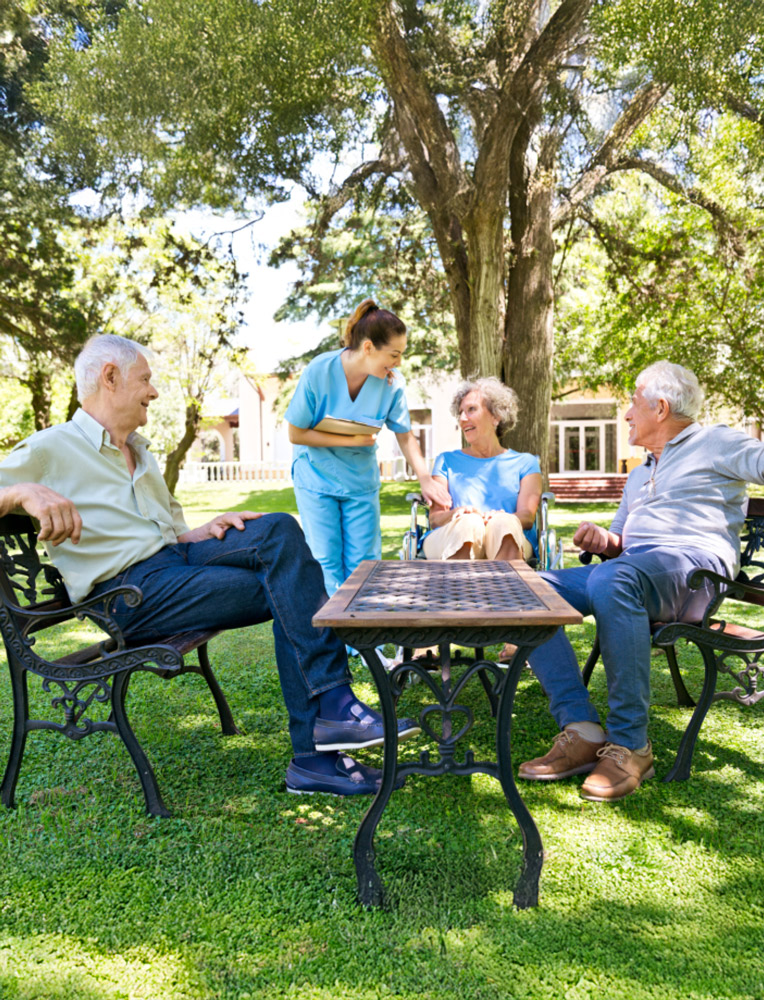 Residents chatting with staff in a garden